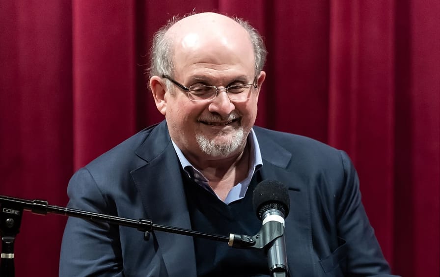 Salman Rushdie speaks on stage at a 2019 discussion of 