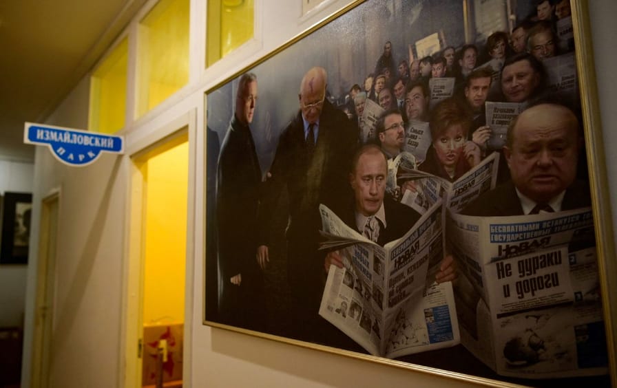 A painting in Novaya Gazeta's Moscow editorial office, of Russian President Vladimir Putin and other political figures reading the independent newspaper.