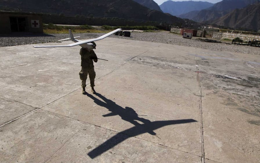 A soldier prepares to launch a drone in Afghanistan.