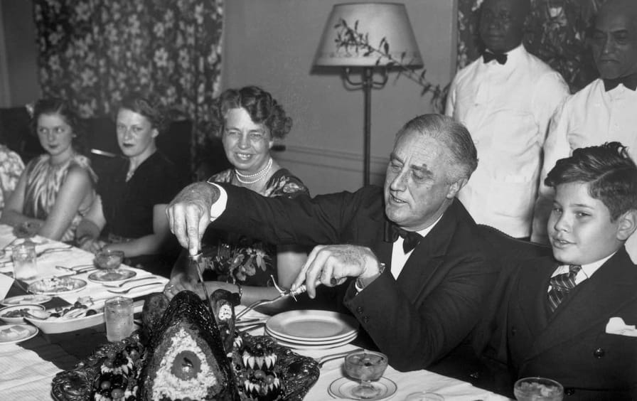 President Roosevelt about to carve a turkey