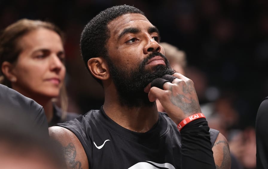 Brooklyn Nets basketball player Kyrie Irving looks on from the bench during the third quarter of the game against the Indiana Pacers at Barclays Center on October 31, 2022.