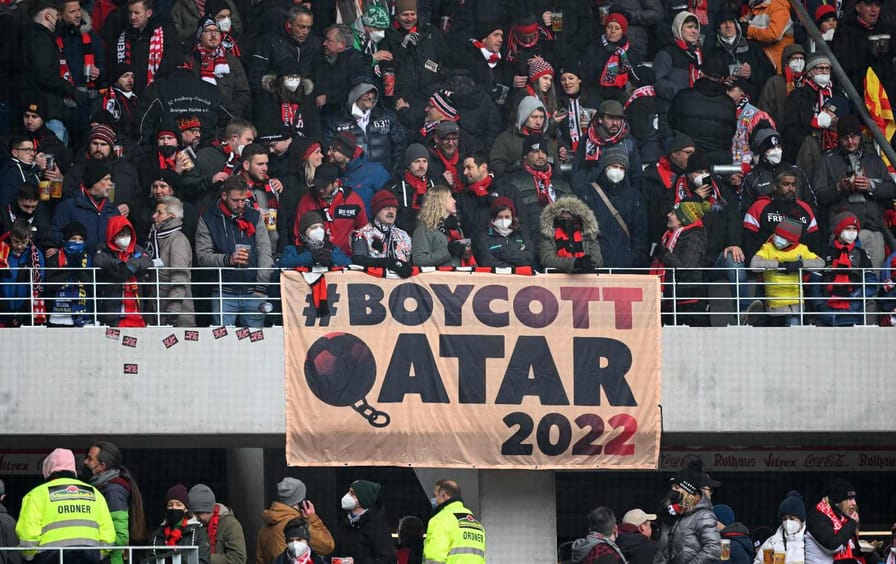 Fans of German soccer team Sport-Club Freiburg display a banner about boycotting the 2022 FIFA World Cup in Qatar prior to a Bundesliga league match against FC Bayern München.