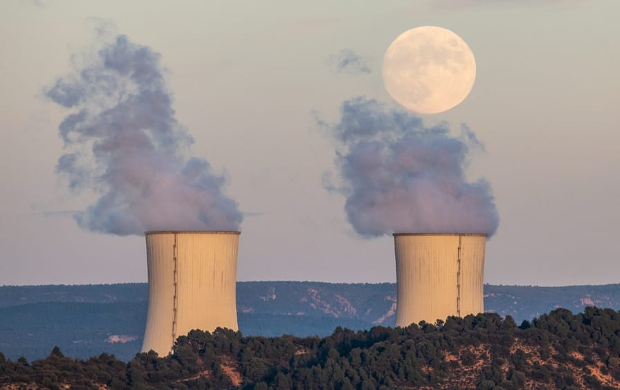 The full moon rises over the cooling towers of the Trillo Nuclear Power Plant in Guadalajara, Spain.