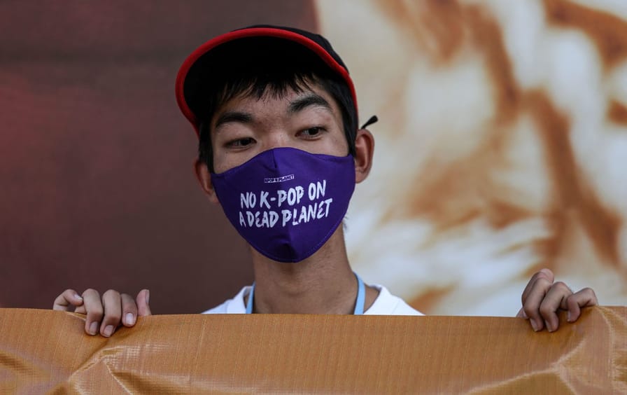 A South Korean climate activist at the COP27 climate conference in Egypt, wearing a face mask reading 