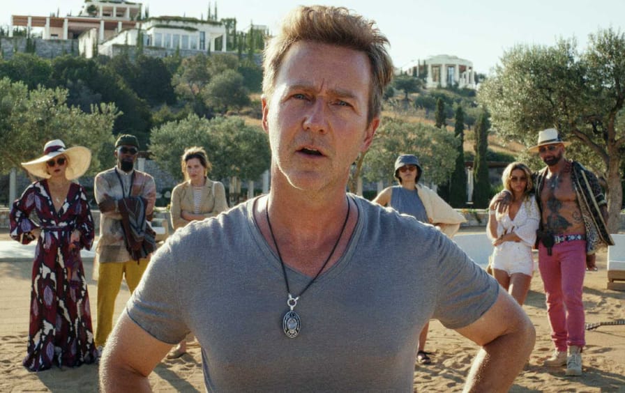 Characters stand on the private island in the Netflix movie Glass Onion: A Knives Out Mystery.