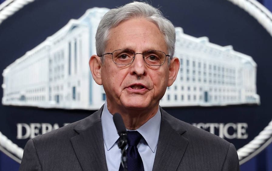 Merrick Garland stands at a podium at the U.S. Department of Justice.