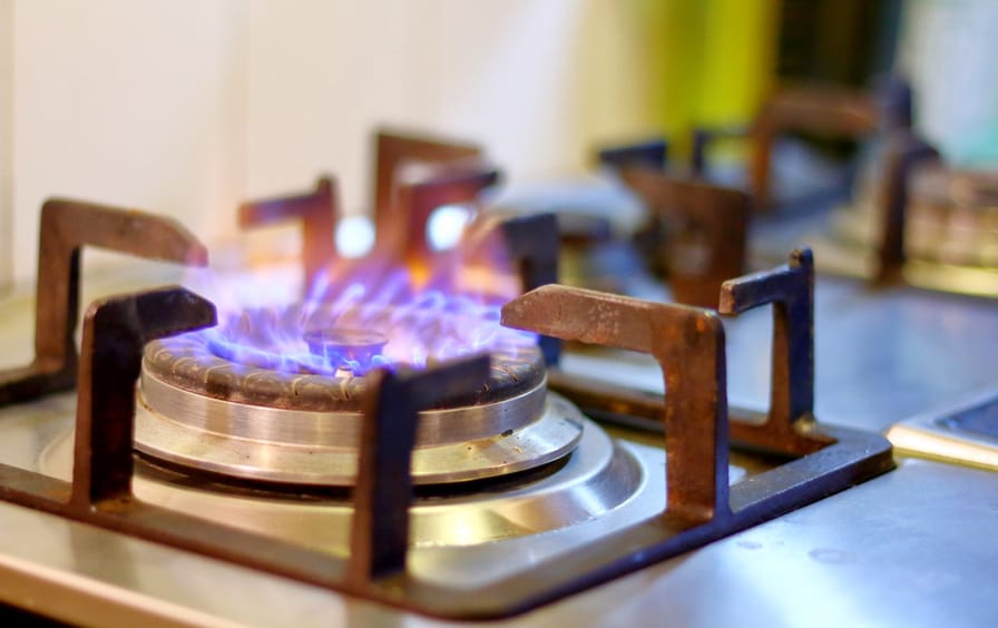 Closeup of burning gas stove in a kitchen.