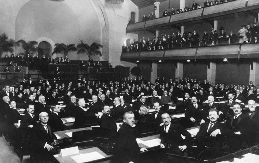 Members of the League of Nations looking over their shoulders during an assembly in Geneva, Switzerland, 1920