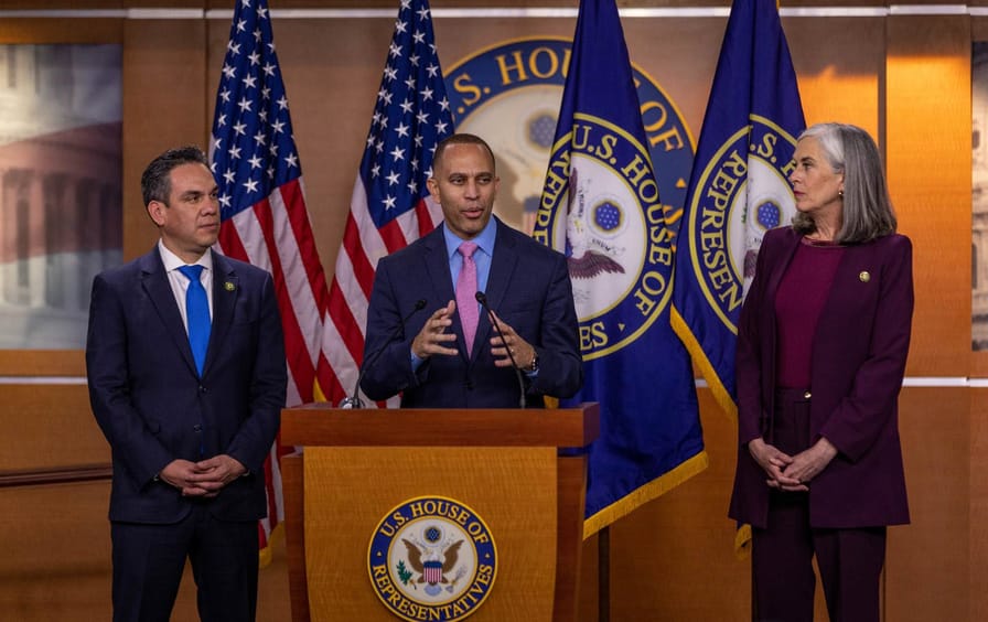 Hakeem Jeffries at the podium with Reps. Katherine Clark and Pete Aguilar