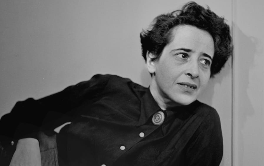 A black and white photo of a young Hannah Arendt lounging.