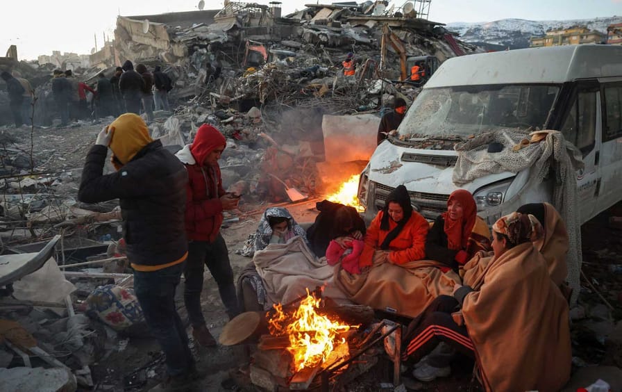 Survivors outside collapsed buildings in Kahramanmaras on February 8, 2023