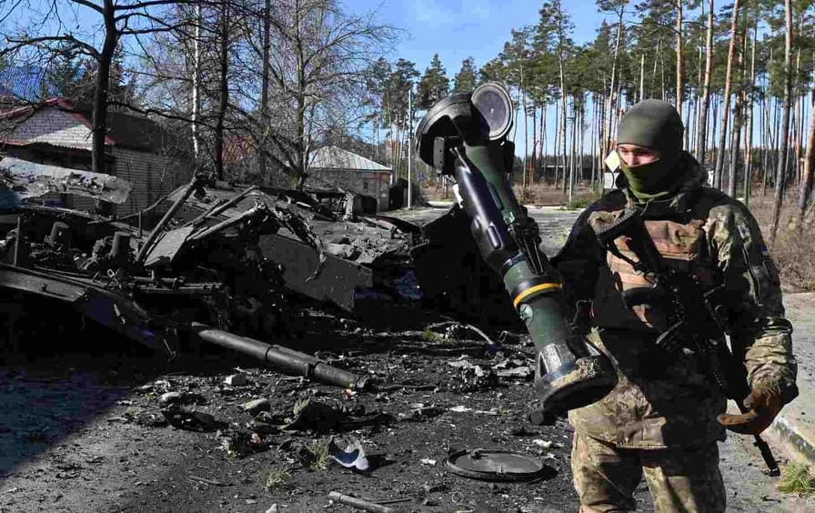 A Ukrainian soldier holds a Next Generation Light Anti-tank Weapon that was used to destroy a Russian armored personal carrier in Irpin, north of Kyiv, on March 12, 2022.
