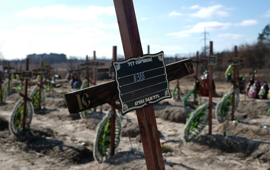 Crosses mark the graves of civilians killed during the invasion whose remains have yet to be identified, in a cemetery in Bucha on March 18, 2023.