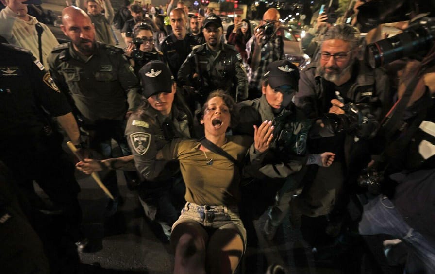 Israeli security forces detain a protester
