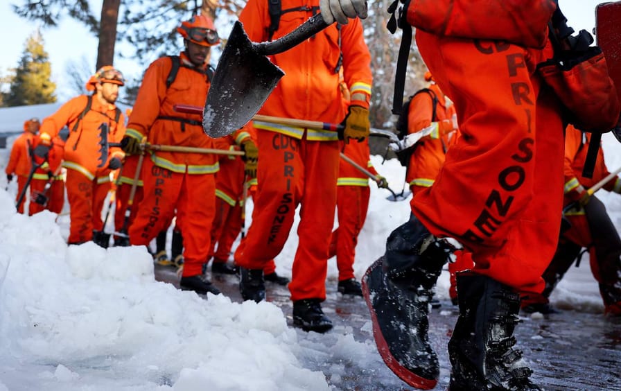 incarcerated firefighters walk through snow