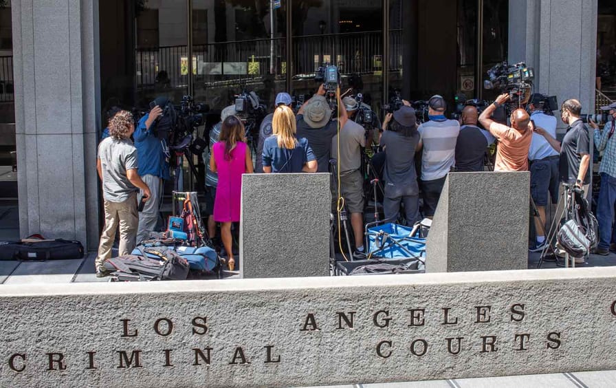 Reporters outside the front doors of the Los Angeles Criminal court.