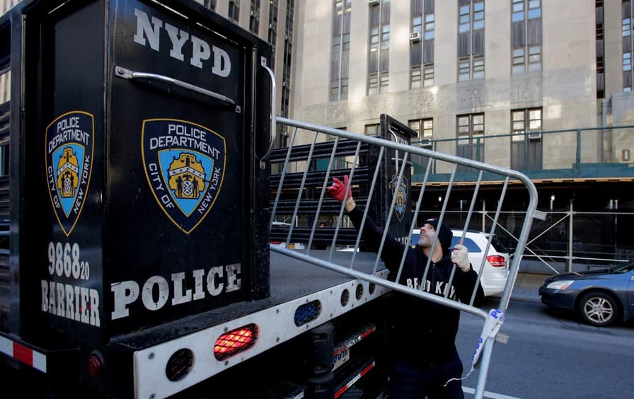 Workers with the New York Police Department set up barricades outside the Manhattan District Attorney Alvin Bragg’s office in New York City on March 20, 2023.