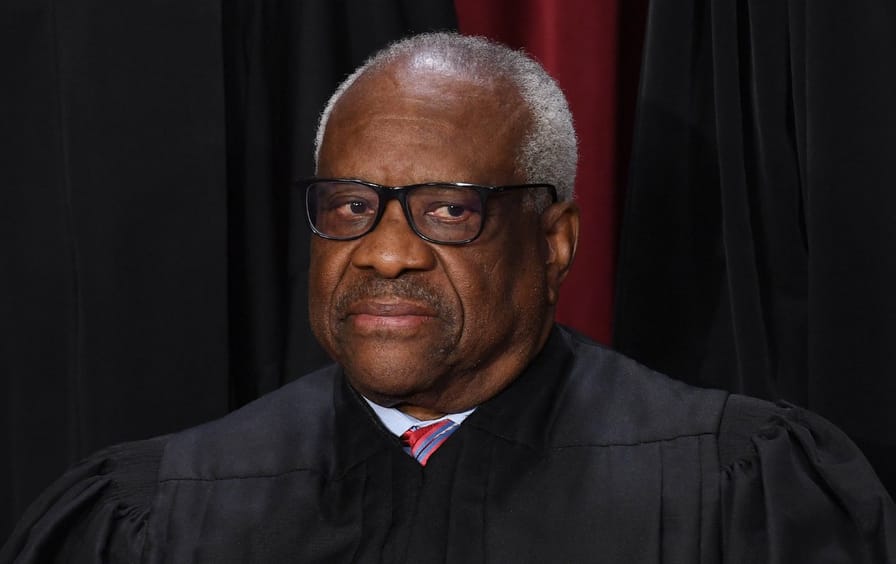 Associate US Supreme Court Justice Clarence Thomas poses for the official photo at the Supreme Court in Washington, D.C., on October 7, 2022.