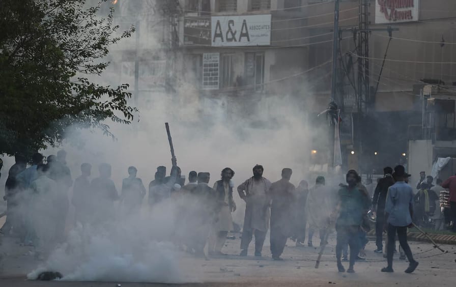 Pakistani security forces fire tear gas during a protest in Rawalpindi on May 9.