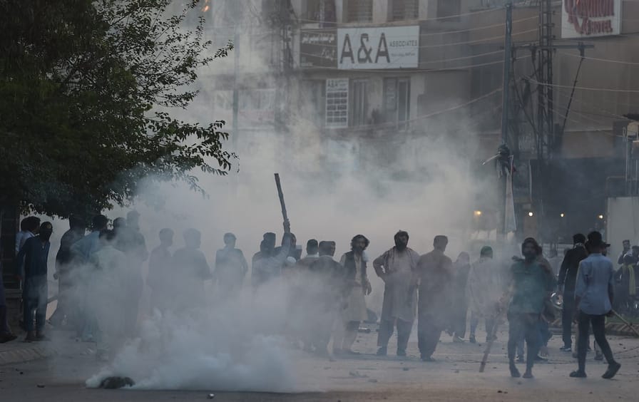 Pakistani security forces fire tear gas shells at supporters of former prime minister Imran Khan