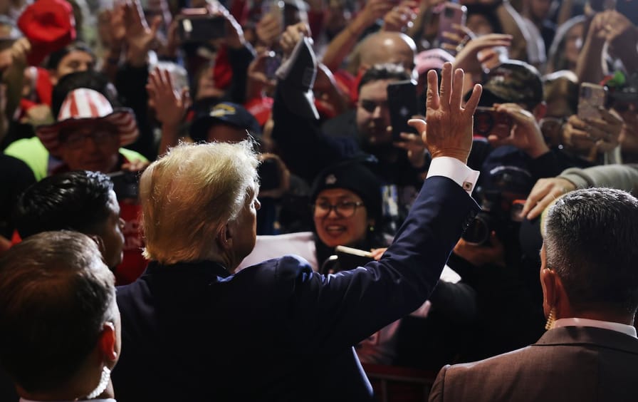 Former president Donald Trump greets supporters at a campaign rally in