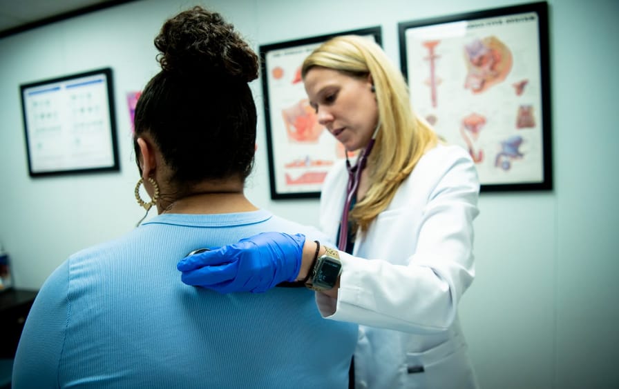 Woman receiving breast exam