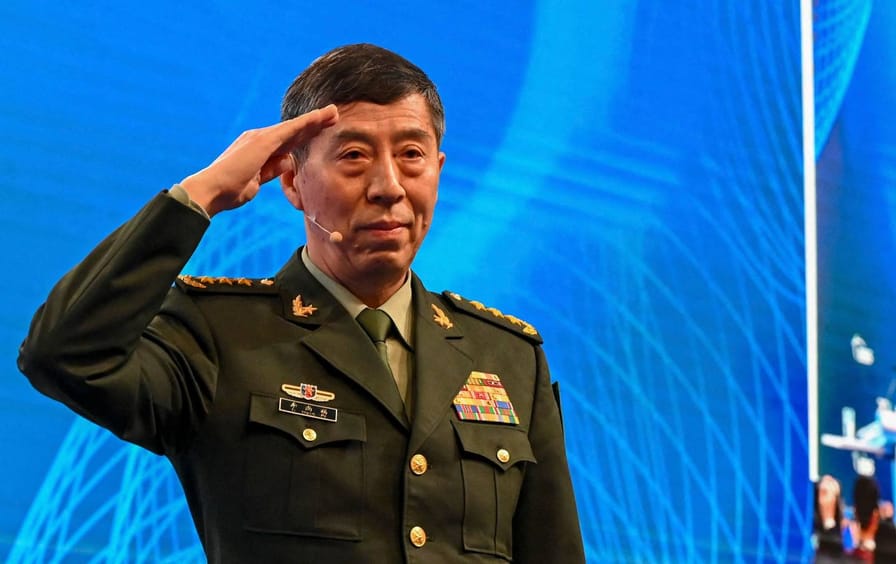 China's Minister of National Defense Li Shangfu salutes the audience before delivering a speech during the 20th Shangri-La Dialogue summit in Singapore on June 4, 2023.