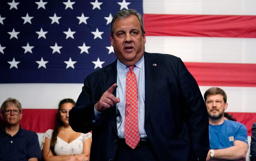 Chris Christie speaking in front of a large American flag.