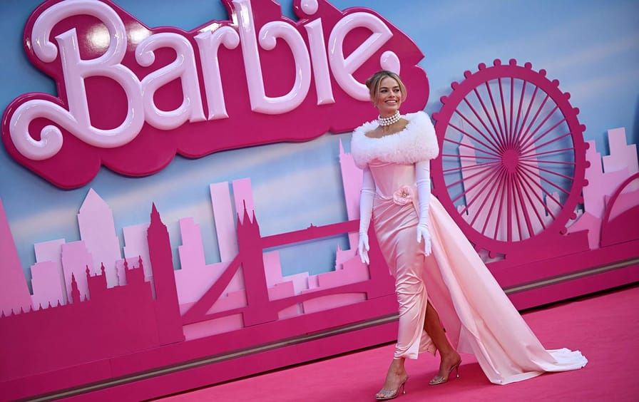 Margot Robbie posing on the pink carpet.