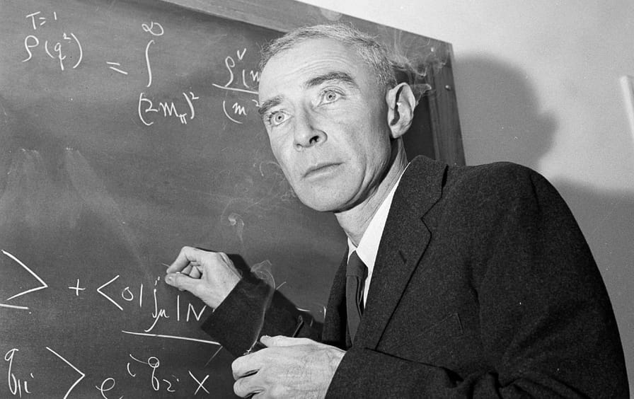 Dr. J. Robert Oppenheimer writes on a blackboard at Princeton, 1957