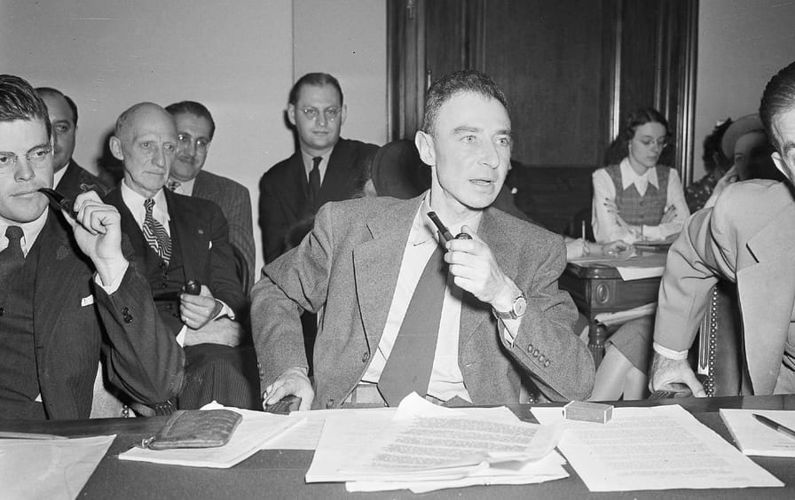 black and white photo of j. robert oppenheimer testifying before the senate