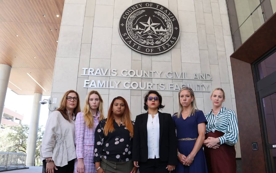 Six plaintiffs in Zurawski v. Texas stand in front of Texas's Travis County Civil and Family Courts Facility Under the court's name and seal.