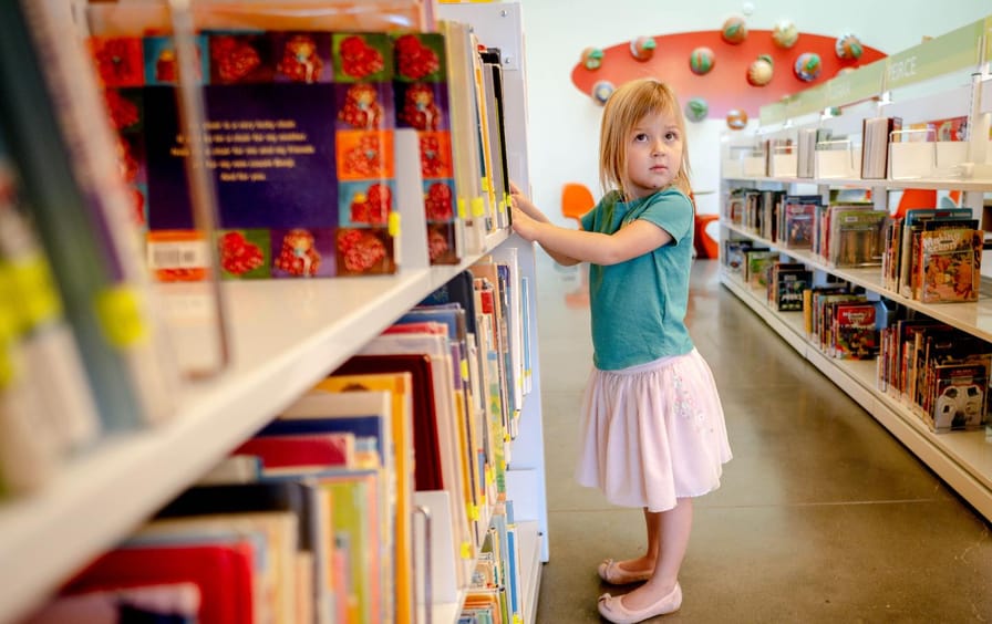 Georgia Knecht, 4, browses a bookshelf at Riverside, California, Main Library.