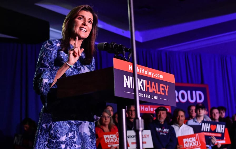 Nikki Haley speaking at a podium at an event for voters.