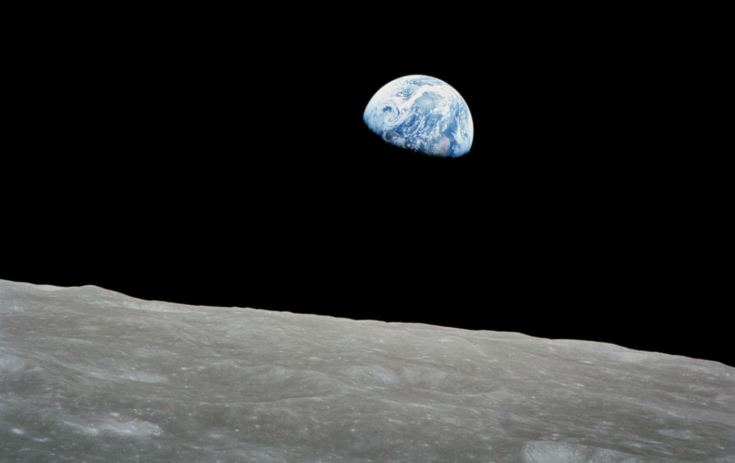 Earth rising on the lunar horizon