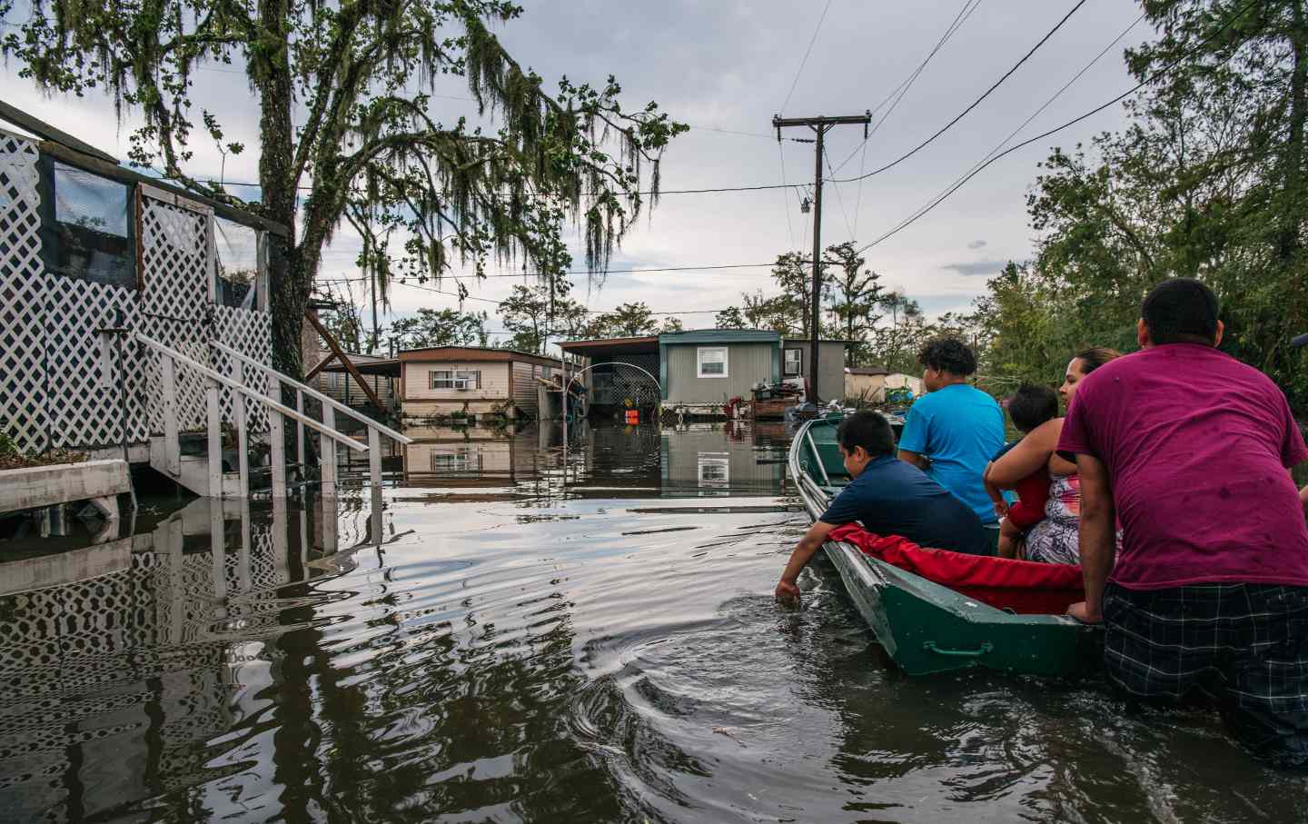 A New Orleans family travels to their home near New Orleans, La., after it was flooded during Hurricane Ida on September 13, 2021.