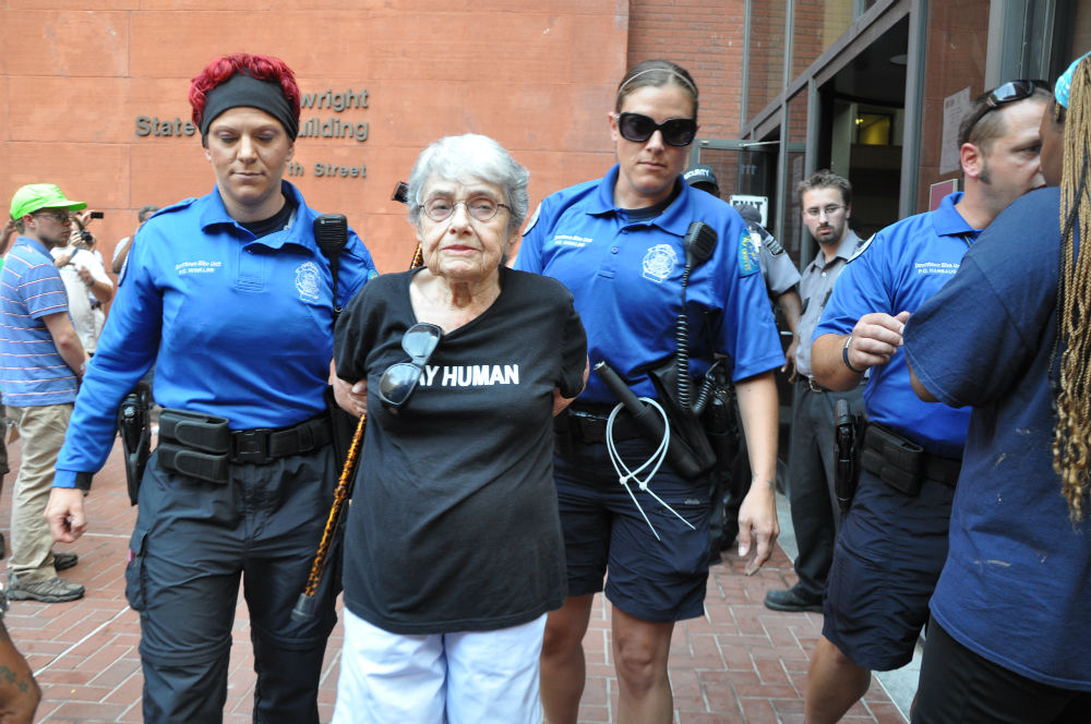 pemSt.-Louis-Metropolitan-Police-officers-escort-Hedy-Epstein-a-90-year-old-Holocaust-survivor-after-arresting-her-for-failure-to-disperse.-Photo-by-Steven-Hsiehemp