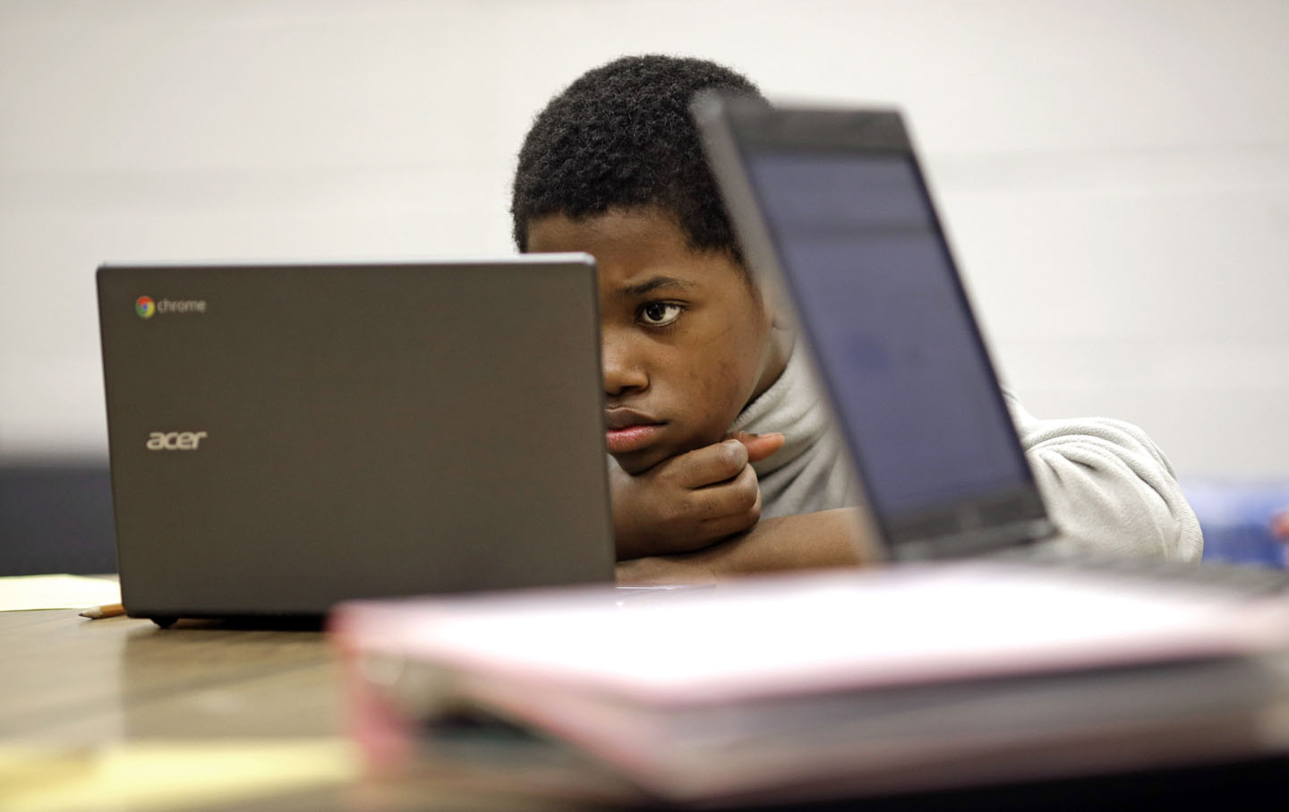 Student reads test questions on laptop