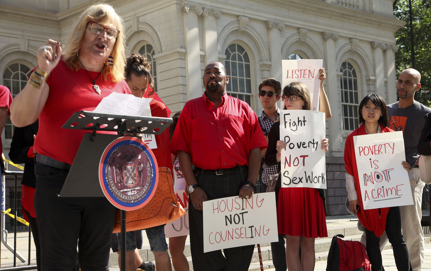 The Red Umbrella Project rallies outside City Hall.