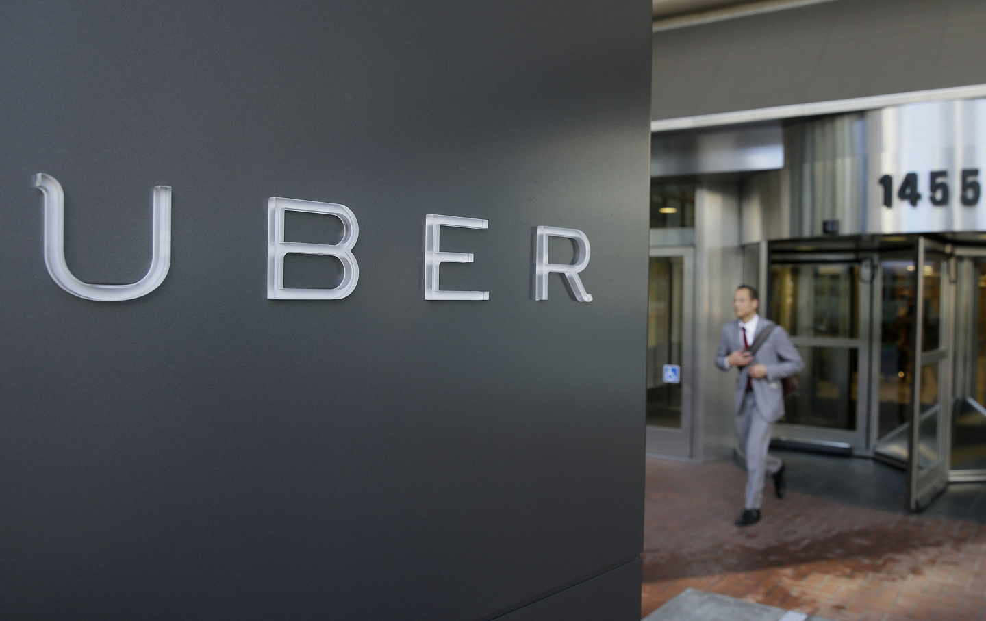A man leaves the headquarters of Uber in San Francisco.