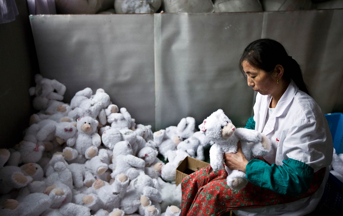 A worker stuffs newly made toys at the production line of a factory in suburban Shanghai.