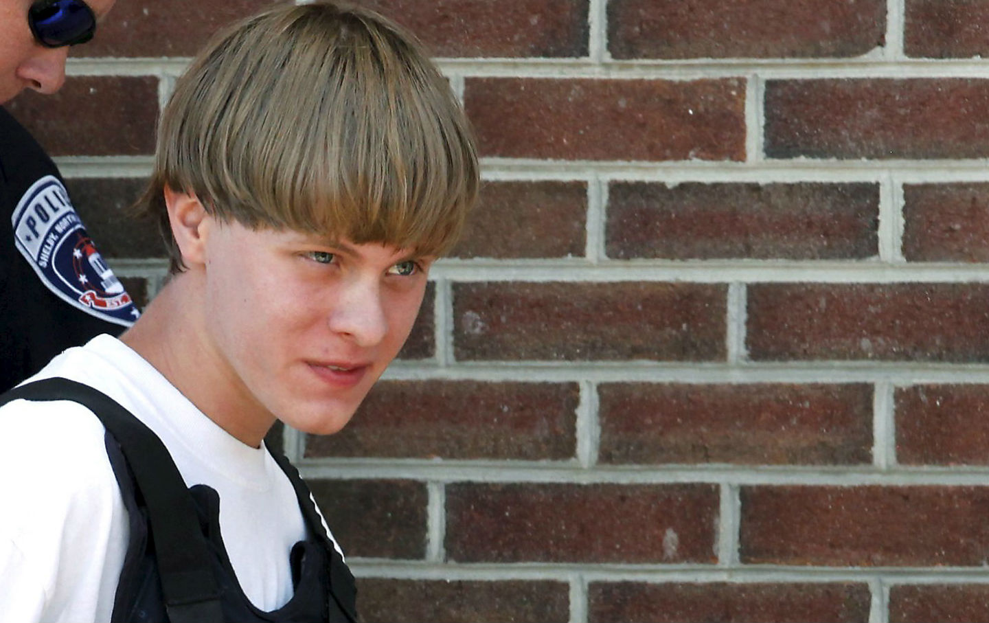 Police lead suspected shooter Dylann Roof, 21, into the courthouse in Shelby, North Carolina, June 18, 2015. Roof, a 21-year-old with a criminal record, is accused of killing nine people at a Bible-study meeting in a historic African-American church in Charleston, South Carolina.