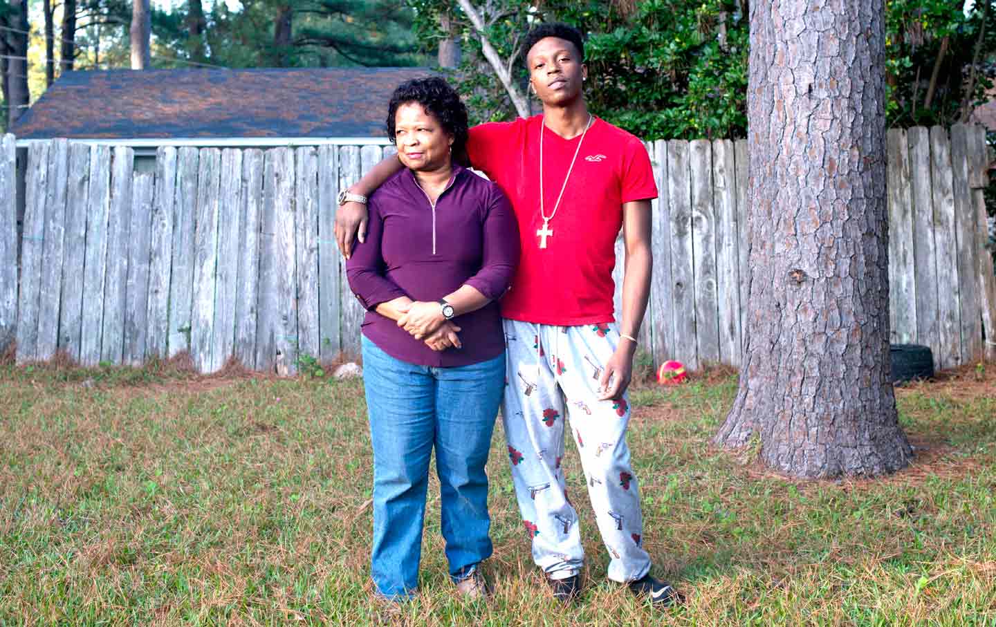 Linda and Keshawn Green pose in their backyard and (inset below) with Charles Green, loving husband and dad, who is serving a life sentence.