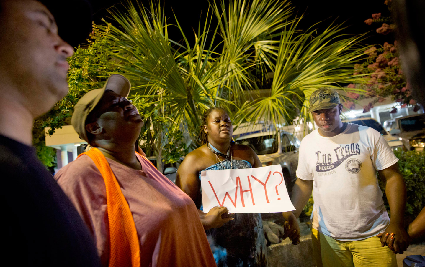 Surreace Cox, of North Charleston, South Carolina, holds a sign during a prayer vigil down the street from the Emanuel AME Church following the mass shooting there.
