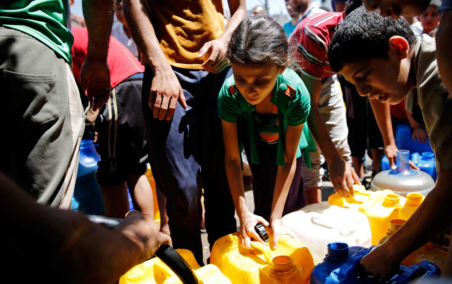 Palestinian child collecting water