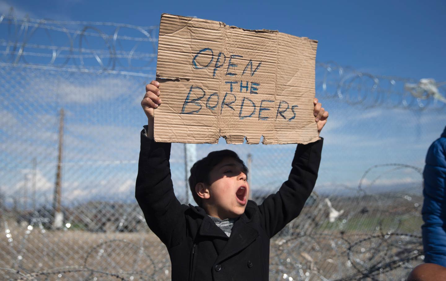 Refugee holding a sign