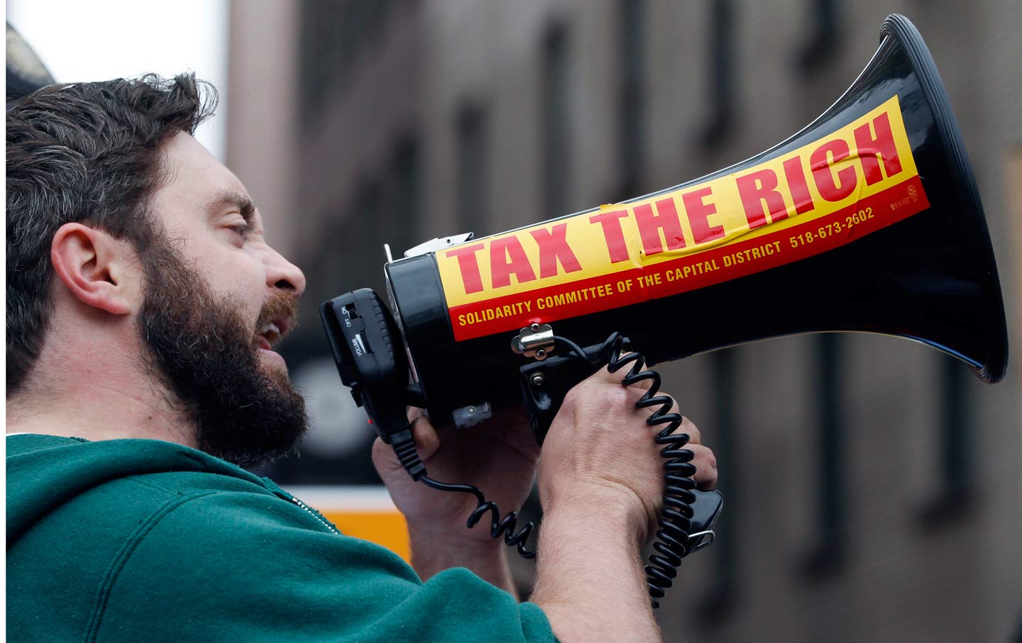 A protester with a bullhorn at a protest in Albany