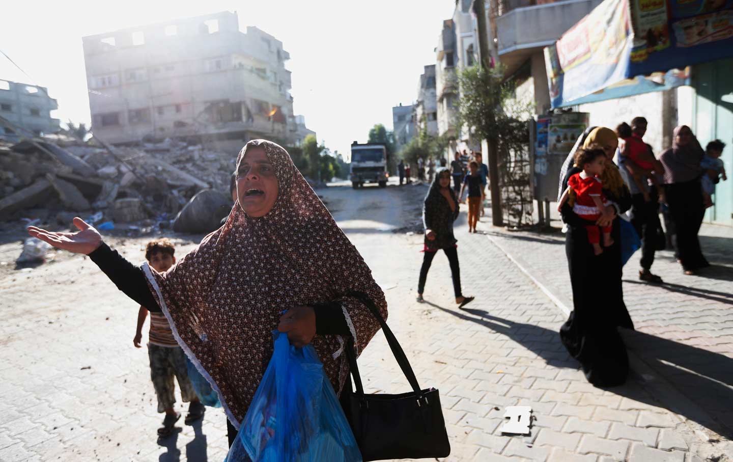 Woman fleeing home in Gaza