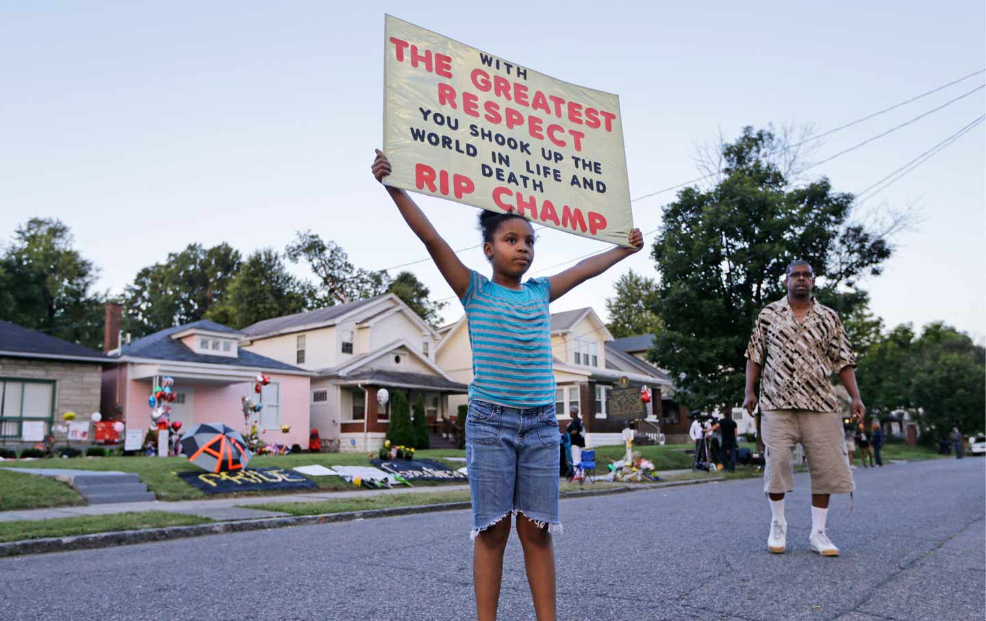 Girl Holds Sign Honoring Ali