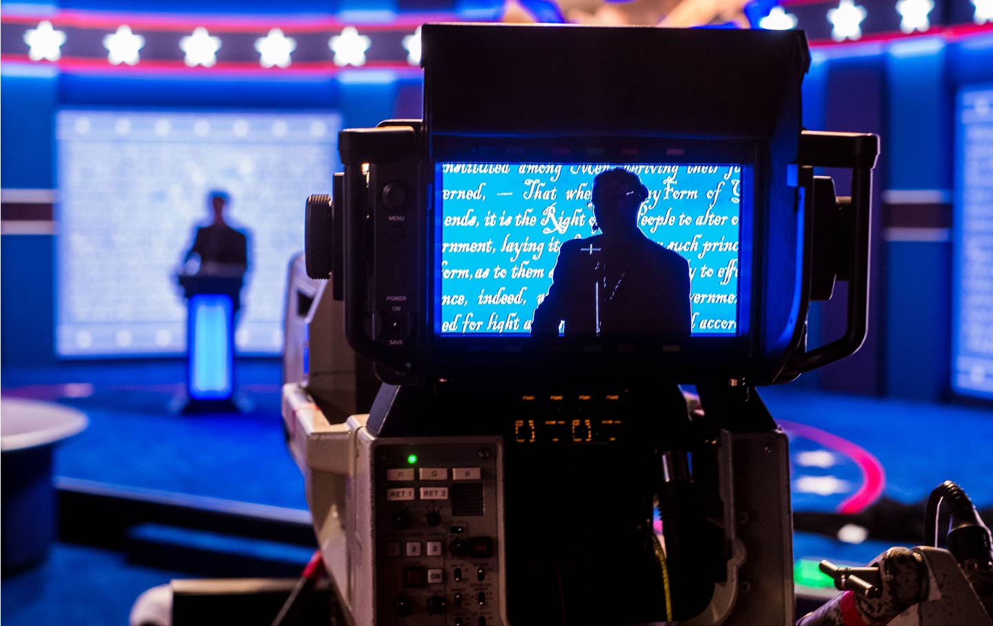 Person in monitor on debate stage